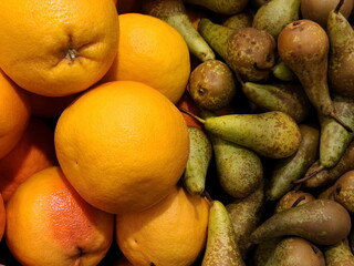 background of ripe fresh oranges and pears. Harvest from own garden