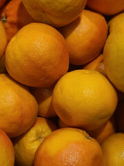 fresh orange fruits without leaves as background, top view