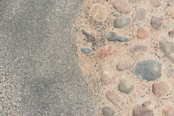 low angle selective focus on asphalt overlay paving on top of a concrete base of a residential street