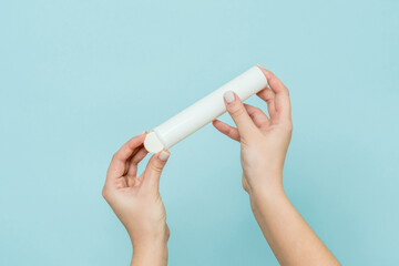 Packaging for vitamins, pills with tablet in hand. White tube. Mockup