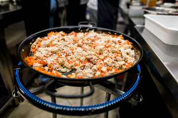 Front photo of cooking rice with meat and vegetables in frying pan