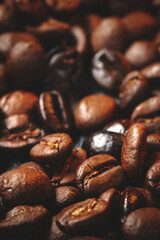 close up view of brown coffee seeds on dark surface group textured grains