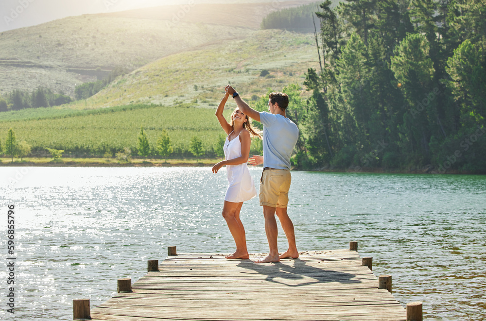 Poster my heart beats for you. shot of a young couple bonding while standing on a jetty at a lake.