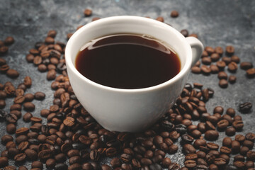 Naklejka premium front view of brown coffee seeds with cup of coffee on dark surface textured grain