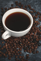 front view of coffee seeds with cup of coffee on dark surface textured cocoa grain group