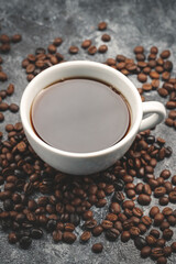 top view of brown coffee seeds with cup of coffee dark surface group grain textured