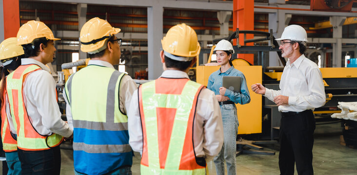 woman worker and engineer under inspection and checking production process on factory station. Factory Engineer. Professional Heavy Industry Engineer Worker. Team of factory workers.