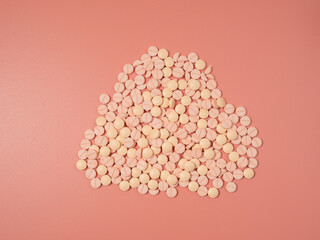 Pink pills on a pink background. Medical tablets. Pills close-up.