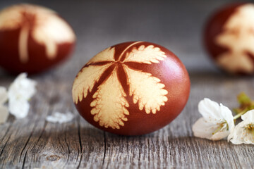 Easter egg dyed with onion peels on wooden background