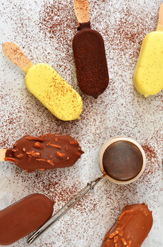 assorted i ce cream on a stick sprinkled with cocoa