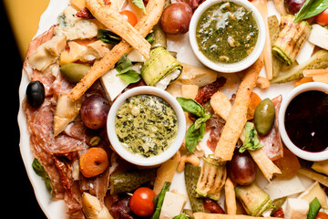 Plate with snacks. Mix of cheese, jamon, sausages and vegetables. Top view