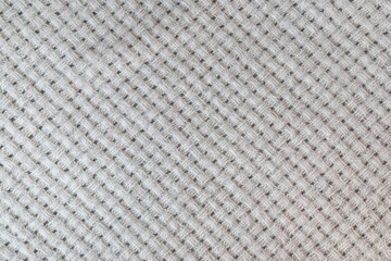 Warm and cozy beige woven blanket as a background