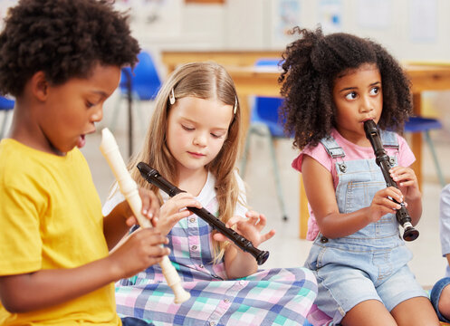 The flute is our favourite instrument. Shot of children learning about musical instruments in class.