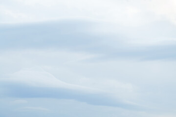 Pale blue sky and clouds background 