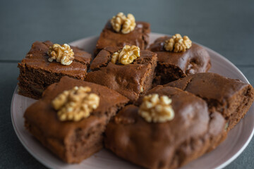 Oatmeal cake with bananas and walnuts on a dark grey background in home kitchen