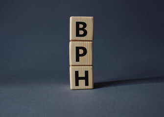 BPH - Benign Prostatic Hyperplasia symbol. Wooden cubes with word BPH. Beautiful grey background. Medical and BPH concept. Copy space.