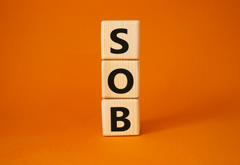 SOB - Shortness of breath symbol. Wooden cubes with words SOB. Beautiful orange background. Medical and SOB concept. Copy space.