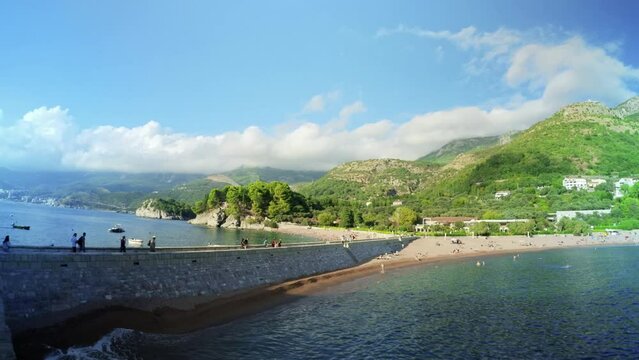 SVETI STEFAN, MONTENEGRO - SEPTEMBER 18, 2021: Beautiful view on Sveti Stefan town, hills and Turquoise Adriatic sea, Montenegro - 4K, Wide shot