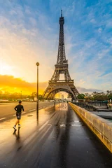 Fototapeten Young man run on the bridge at sunrise time after rain. Morning jogging under Eiffel Tower in Paris, France © pyty