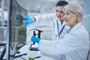 helping one another grow. Shot of a senior scientist teaching her staff.