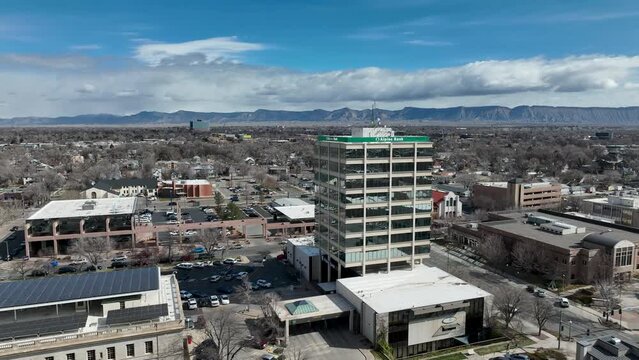 Aerial Union Station train tracks Grand Junction Colorado fast 4K. Urban interstate highway and railroad transportation. Historic business, homes and architecture. City center, cityscape, station.