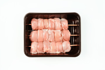 Chicken skewers.Food for retail.Skewers from raw chicken leg meat without skin for a supermarket on...
