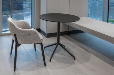 Seating in the foyer of modern office. Modern minimalist desk or worktable office with open space to work with window.