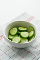 close up of slice of cucumber in a bowl on table 