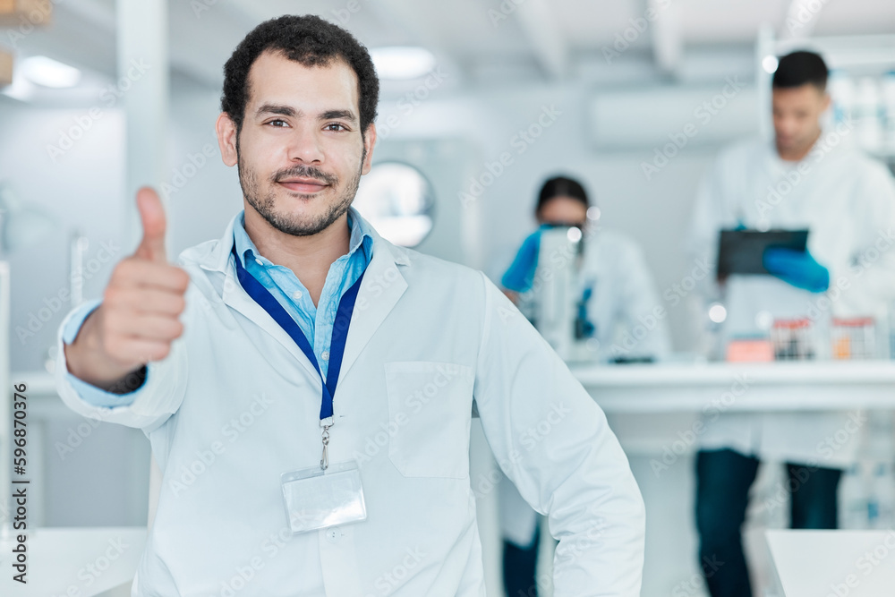 Poster ive made heaps of discoveries today. portrait of a young scientist showing thumbs up in a lab.