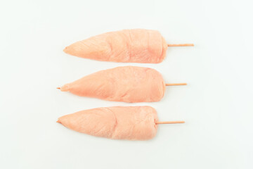 Chicken skewers.Food concept.Skewers from raw chicken meat inner fillet for a supermarket on a white background.Ogranic food,healthy eating.Food for retail.Top view.