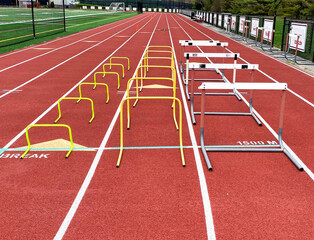 Three different sizes of hurdles in ows on a track for training