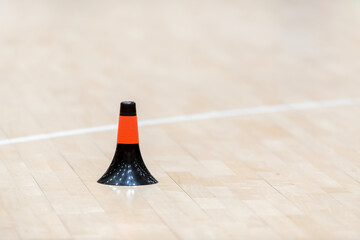 Training cones on hardwood court floor. Basketball, futsal, handball and volleyball practice. Game...