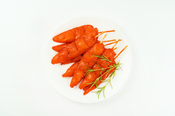 Chicken fillet inner skewers.Fresh raw marinated chicken meat skewers iner fillet on a white background.Top view.Copy space.Chicken fillet inner skewers.Food concept.