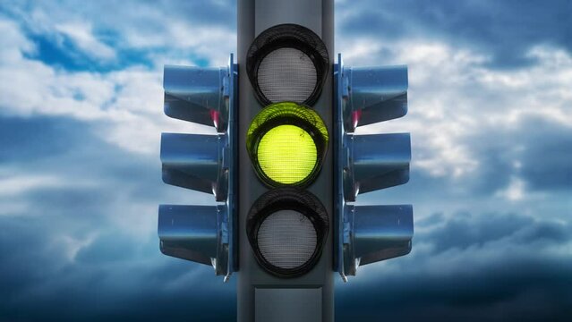 Traffic lights with changing colors against sky with clouds