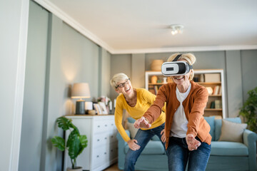 Women two senior females at home enjoy virtual reality VR headset