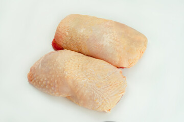 Chicken leg meat.Raw fresh chicken leg meat with skin on white background.Food for retail.Procurement for designers.Ogranic food,healthy eating.Food concept.Top view.Copy space.