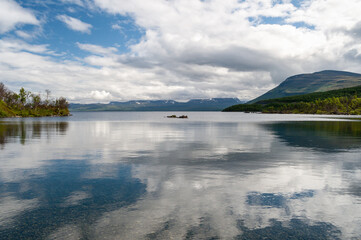 Fototapeta premium Lake water surface and cloud reflection in Abisko National Park, Sweden