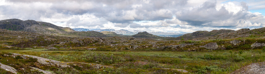 Fototapeta na wymiar Panorama of a mountainous landscape full of hills and rocks in the north of Europe in Norway and Sweden