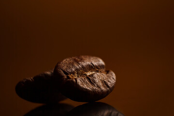 coffee beans on a dark background with a yellow highlight on the background, coffee beans close-up for a coffee shop