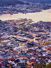Fototapeta premium Aerial shot of Bergen city buildings and streets lit up after sunset, Norway