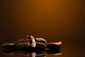 coffee beans on a dark background with a yellow highlight on the background, coffee beans close-up...
