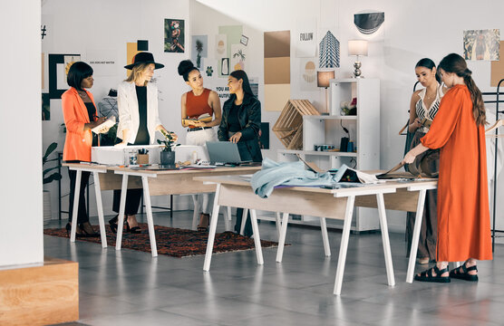 Hustle and bustle. Shot of a group of designers collaborating at a workshop together.
