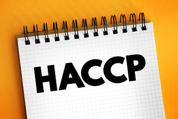 HACCP Hazard analysis and critical control points - systematic preventive approach to food safety from biological, chemical, and physical hazards in production processes, text concept on notepad