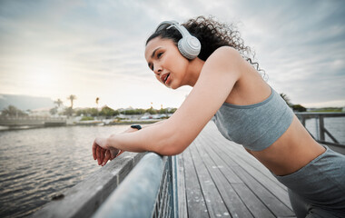 Shes gotta dig deep. Cropped shot of an attractive young female athlete taking a break during her morning run outside.