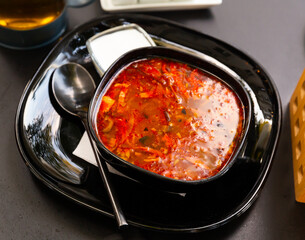 Traditional Russian dish is Solyanka soup, cooked on a steep meat broth. Served with sour cream