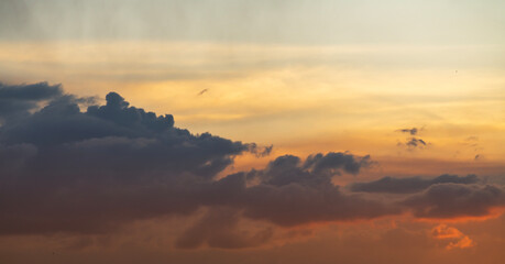 Beautiful bright sunset sky dramatic clouds after rain. Sunset background.