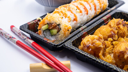 Take away Japanese food. Sushi spicy roll and takoyaki.