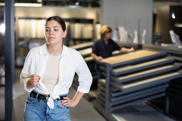 Portrait of female customer making a choice in a plumbing and building materials store