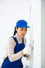 Portrait of builder in process of finishing work in cottage