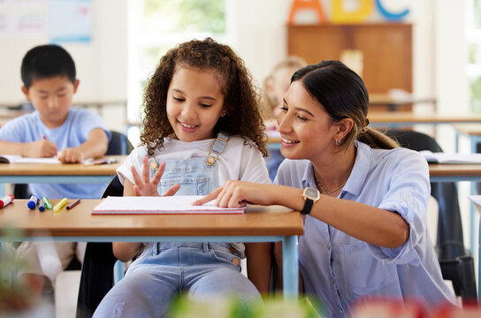 Learning to share is one of the skills we learn at preschool. Shot of a female teacher assisting a preschool learner in her class.
